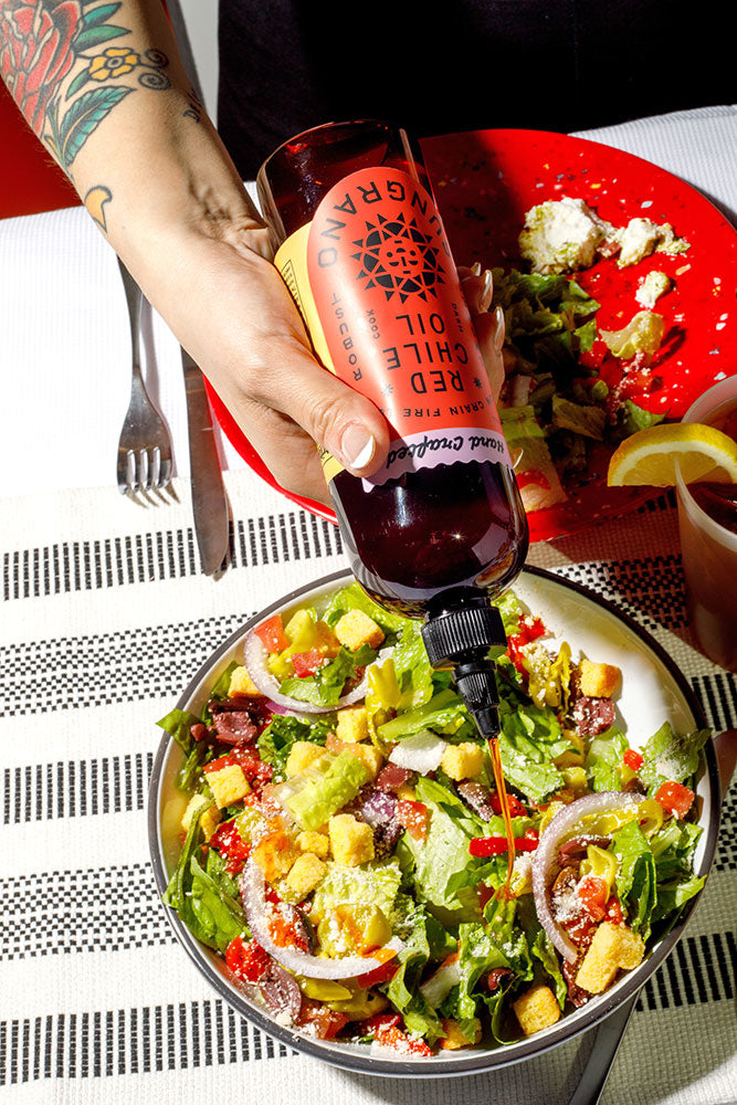 Drizzling Sungrano over a chopped salad